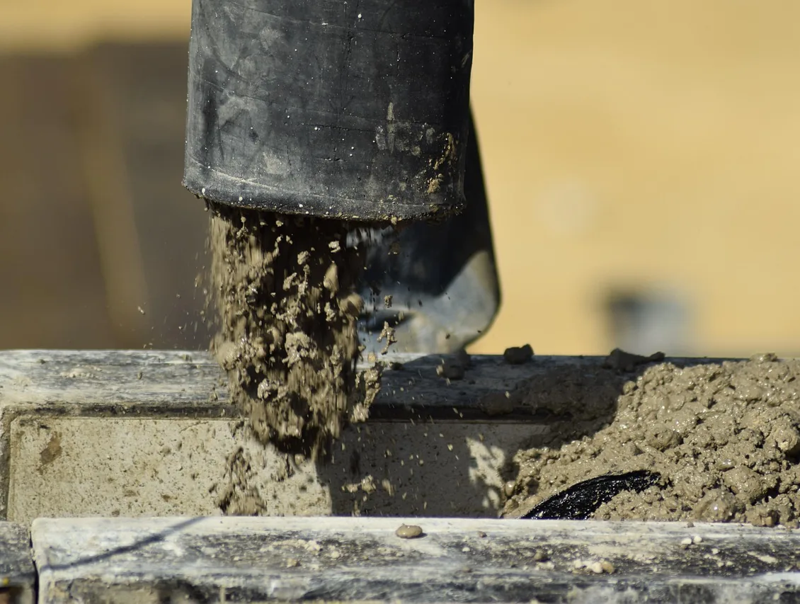 Fresh concrete pouring into a form in Renton WA
